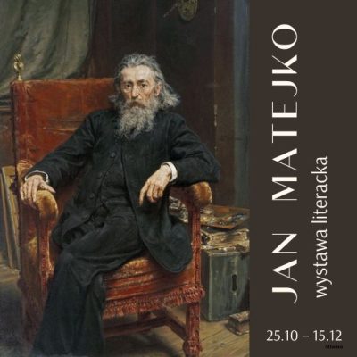 Mężczyzna z długimi włosami i siwą brodą siedzący na fotelu